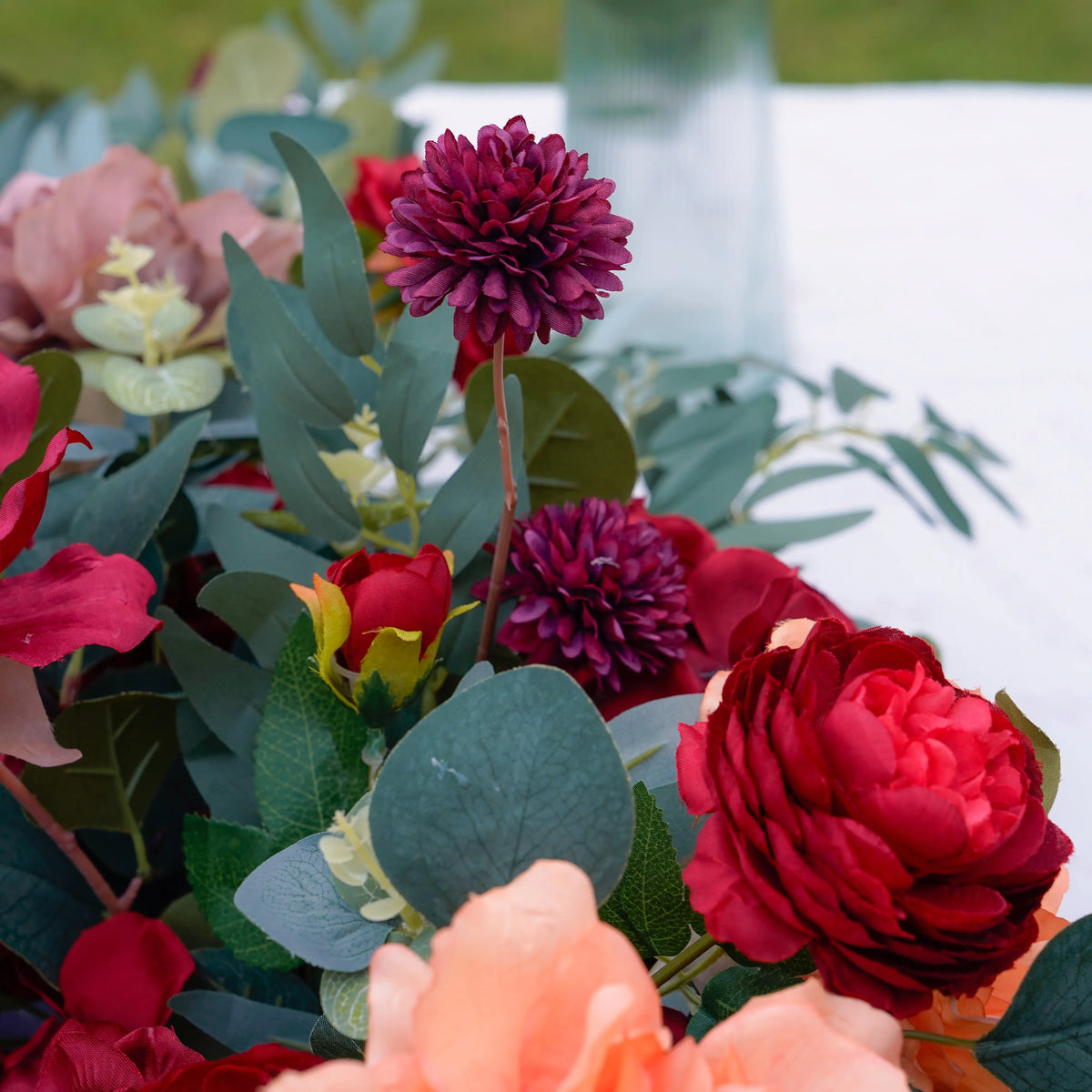 Burgundy pom flower and greenery detail