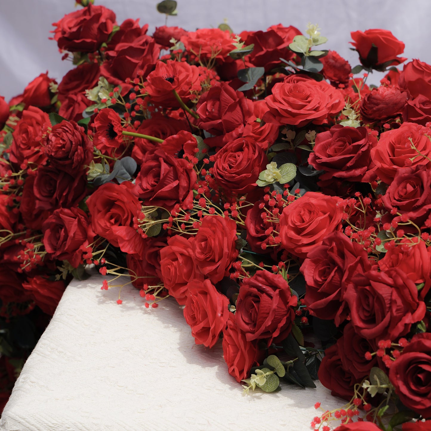Dimensional close-up of red artificial rose table flower runner