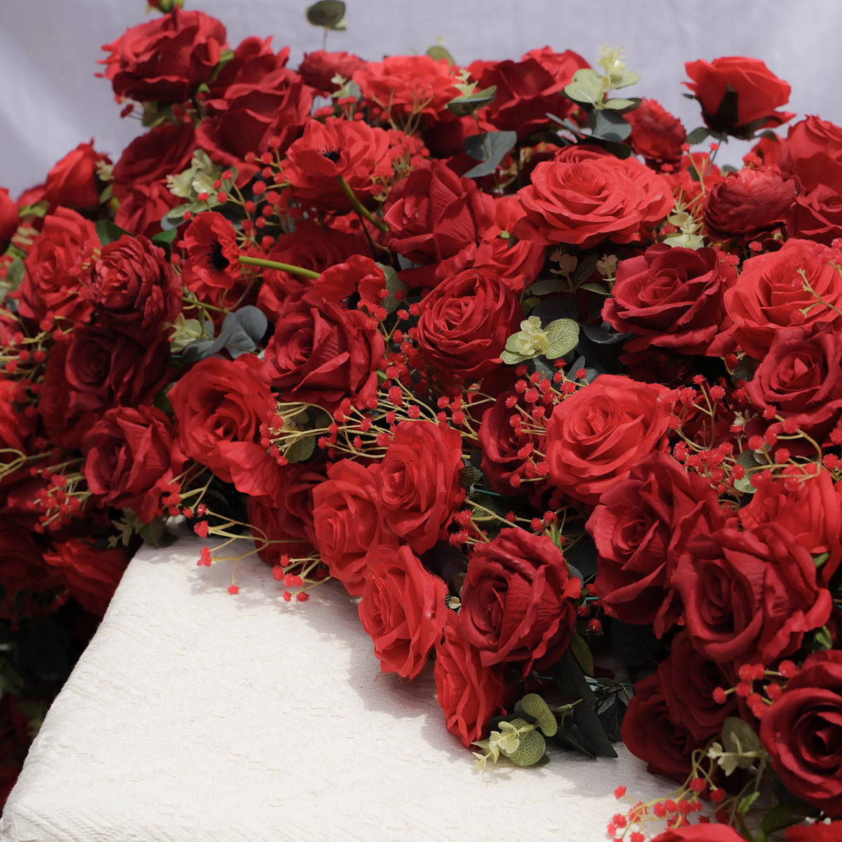 Dimensional close-up of red artificial rose table flower runner