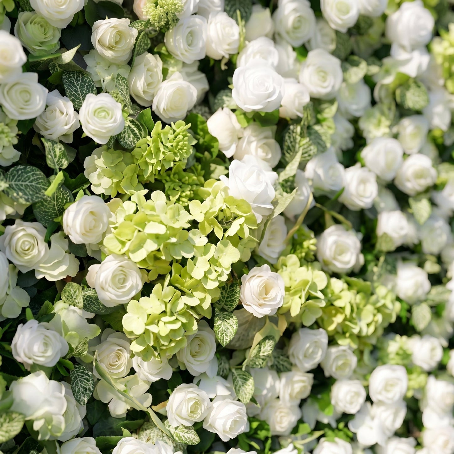 Layered floral detail of white rose and green hydrangea flower wall