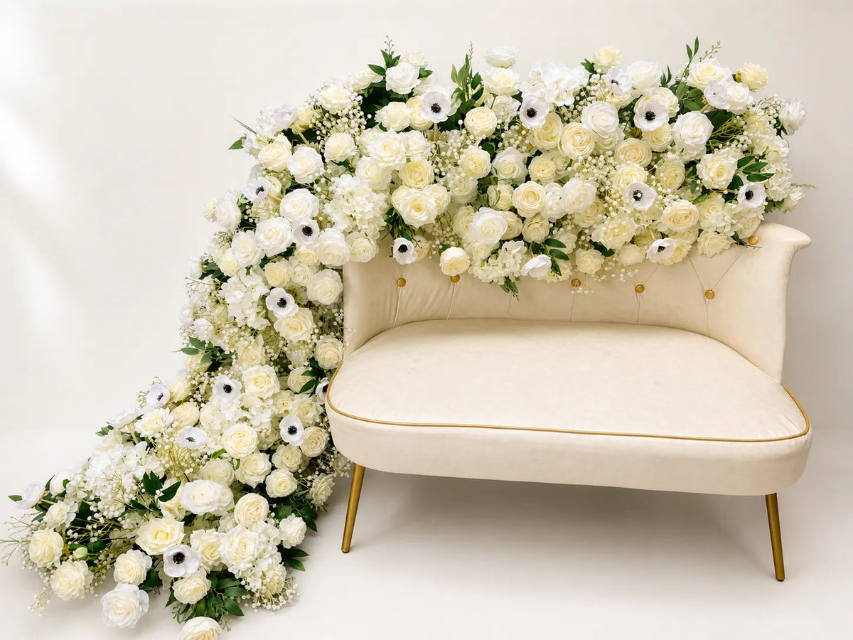 Long white artificial flower runner with roses hydrangeas and greenery in warm white studio