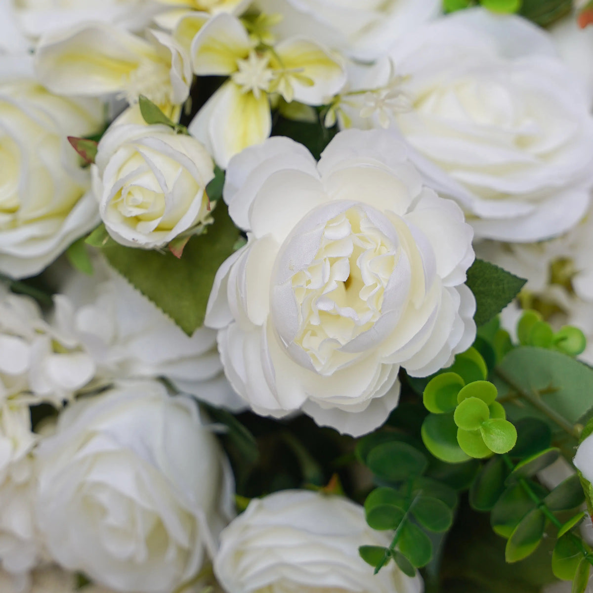 Close-up of white rose and greenery artificial flower runner