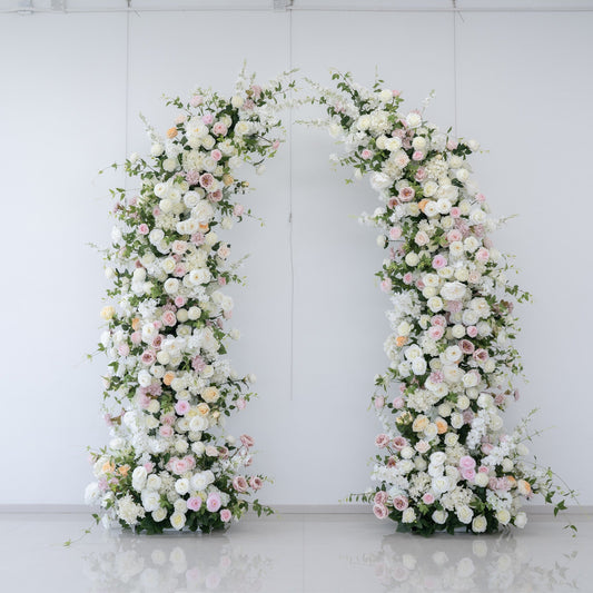White and pink floral wedding arch used as a romantic backdrop