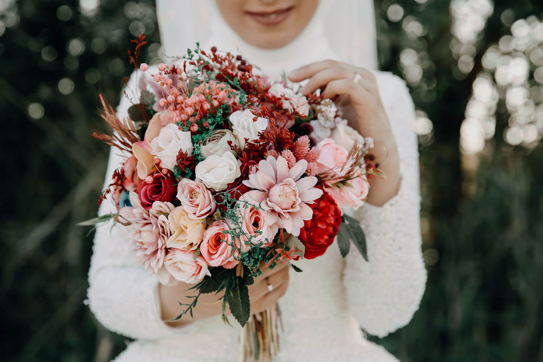 Bride holding a colorful wedding bouquet; editorial inspiration photo, not a Rosy Flower Wall product or client event.