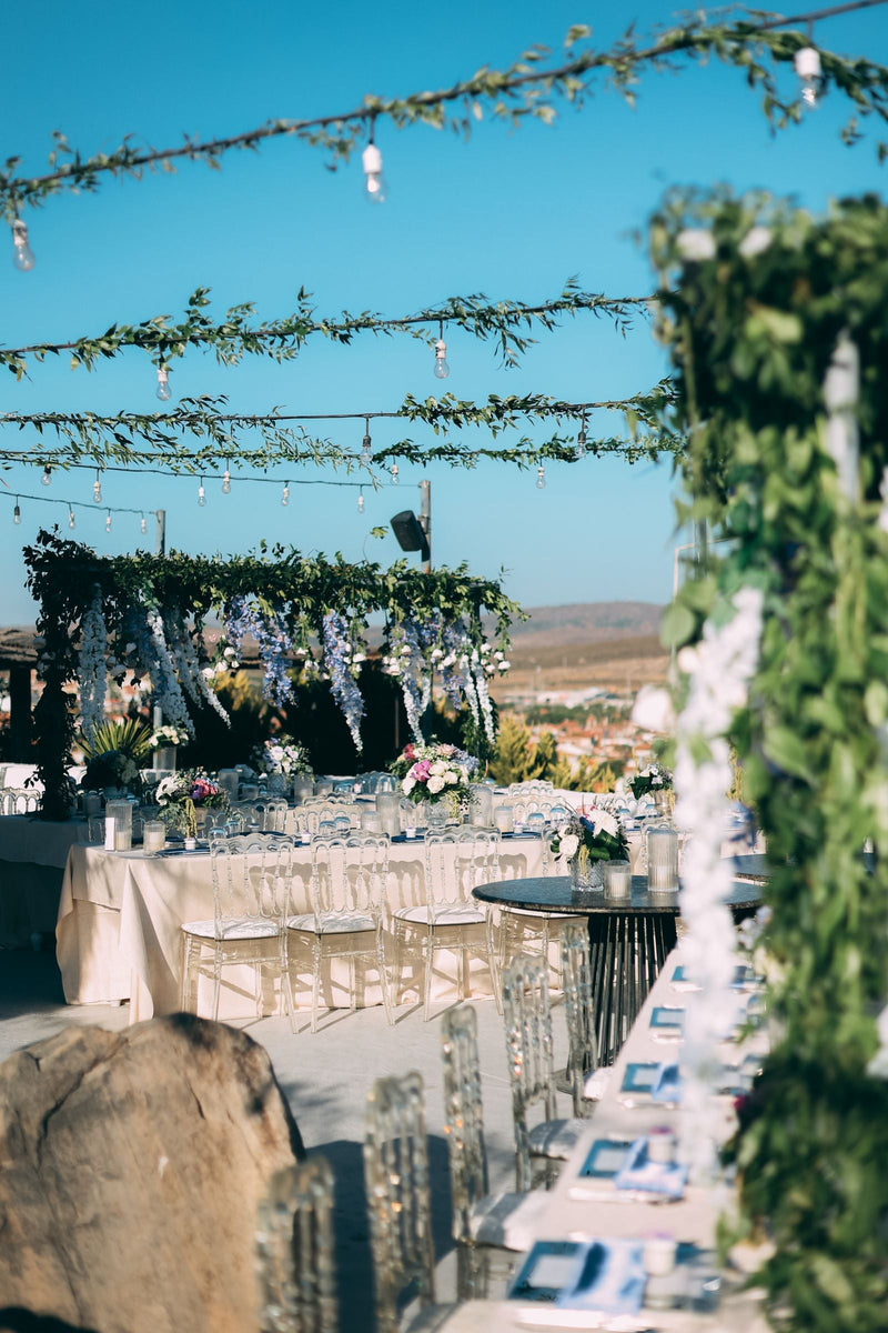 Outdoor wedding reception with greenery and floral decor; editorial inspiration photo, not a Rosy Flower Wall product or client event.