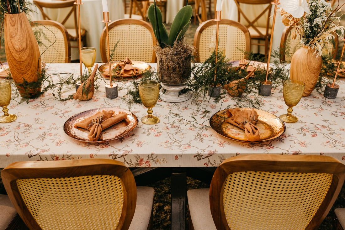 Elegant wedding reception table with candles, greenery and place settings