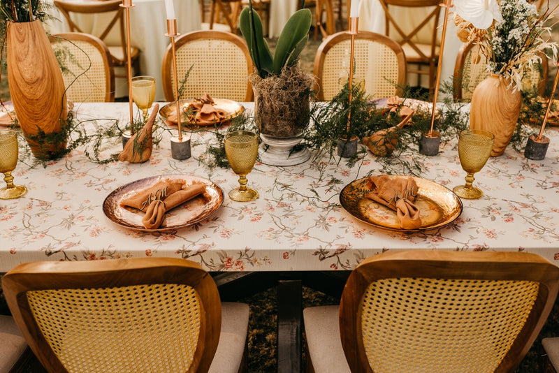 Elegant wedding reception table with candles, greenery and place settings
