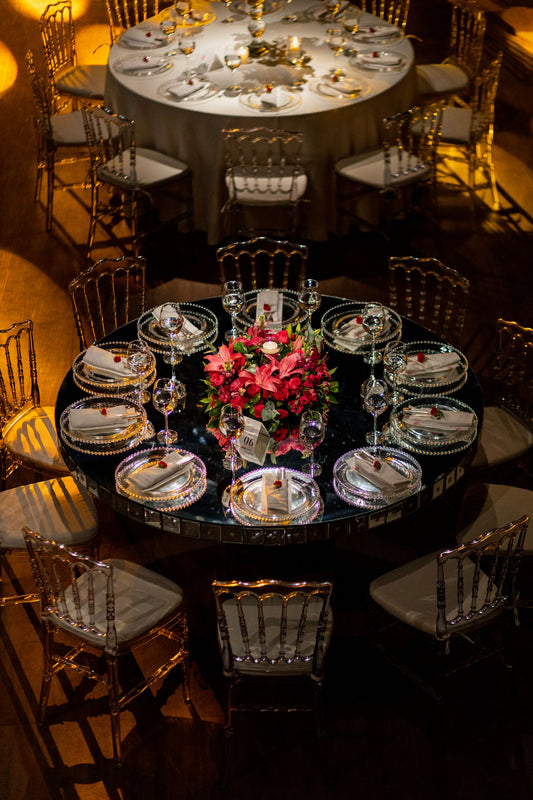 Wedding reception table with a floral centerpiece and place settings
