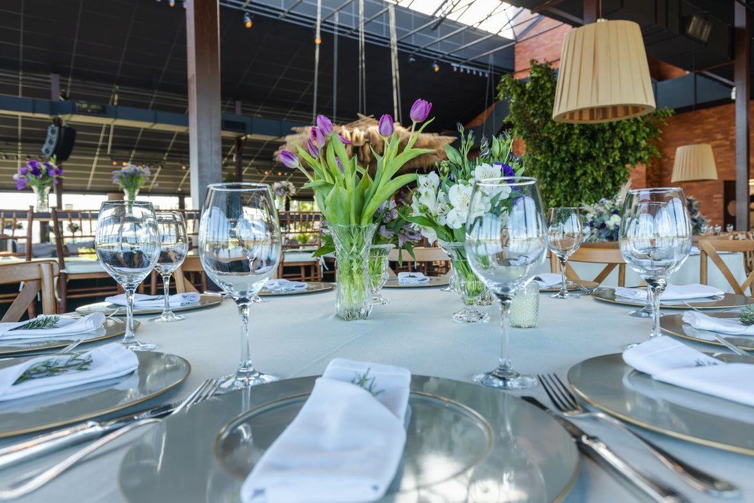 Wedding reception table with glassware and a floral centerpiece