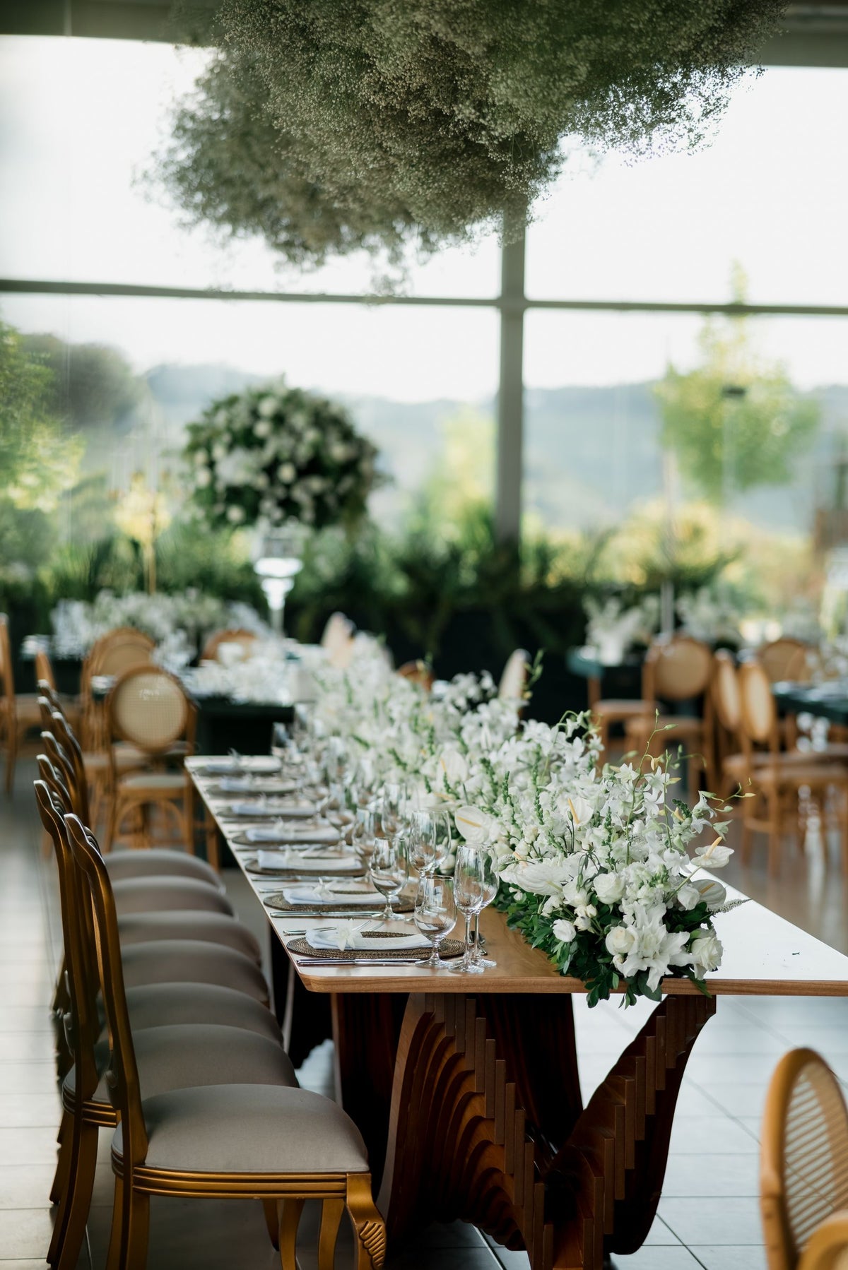 Wedding reception table with white flowers and elegant place settings