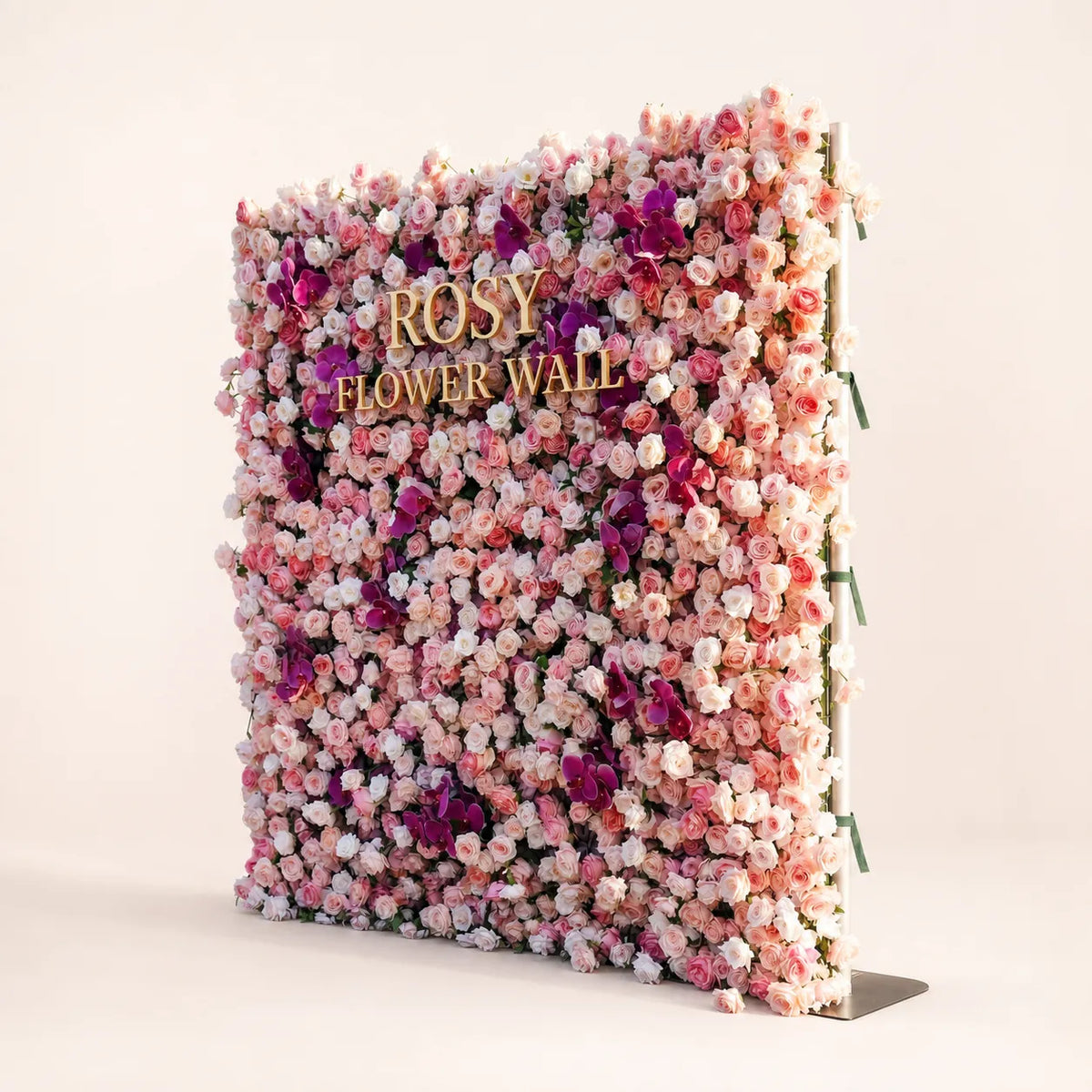 Luxury 4D pink and purple orchid silk flower wall angled side view in warm white studio with gold ROSY FLOWER WALL logo
