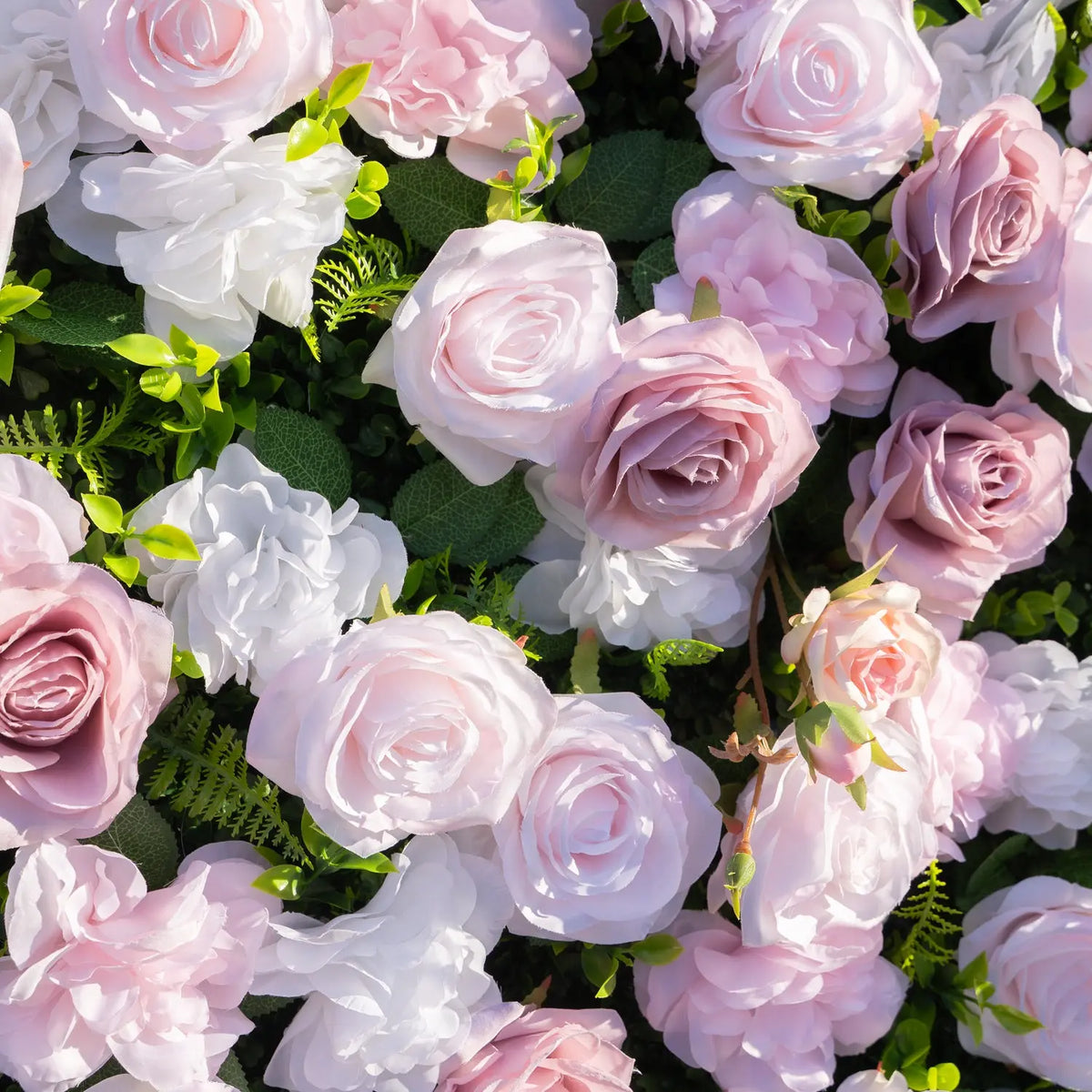 Detailed arrangement of blush roses white flowers and greenery