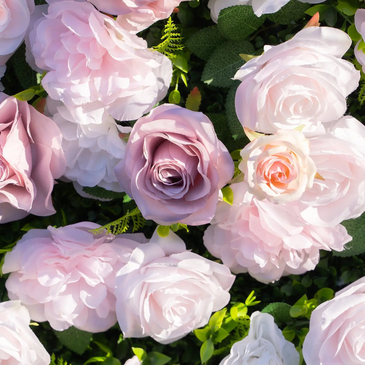 Close-up of layered pink white and mauve artificial flowers