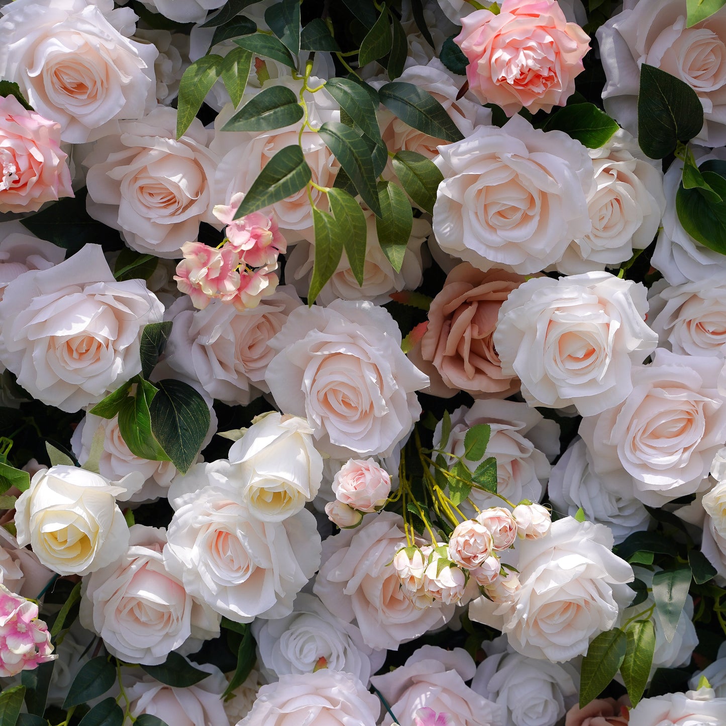 Close-up of peach and white silk flowers on the flower wall