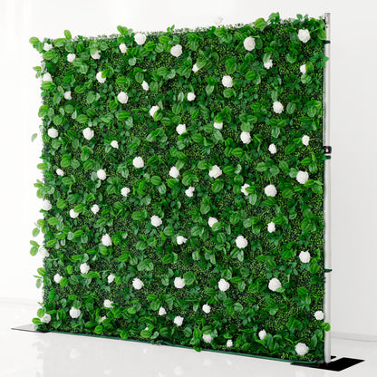 Artificial green wall with white flowers on a stand against a white background