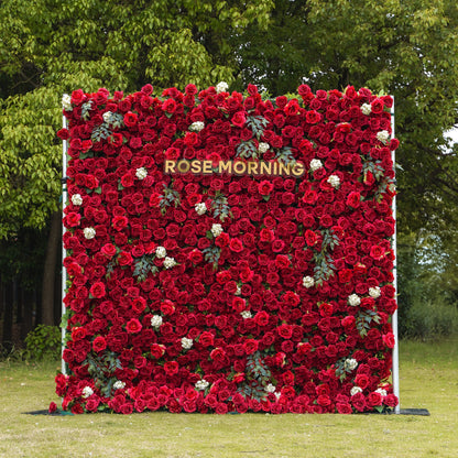 Red artificial rose wall backdrop with green foliage