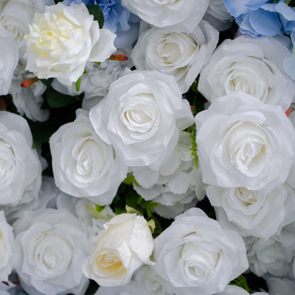 Close-up of blue and white artificial roses and hydrangea-like blooms