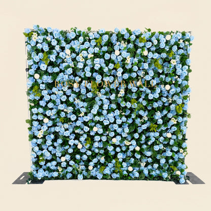 Blue rose flower wall on warm ivory studio background with gold Rosy Flower Wall logo