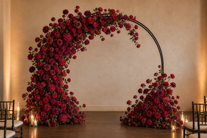 Burgundy red loose artificial flower kit arranged on a large wedding ceremony arch