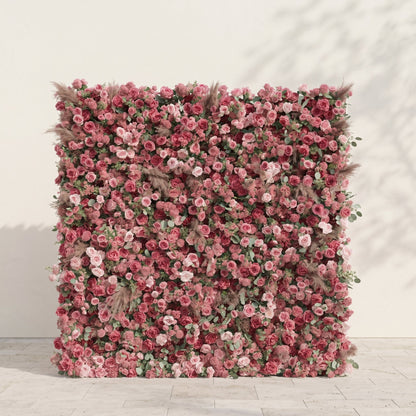 Dusty rose and nude pink silk flower wall on a warm white studio background