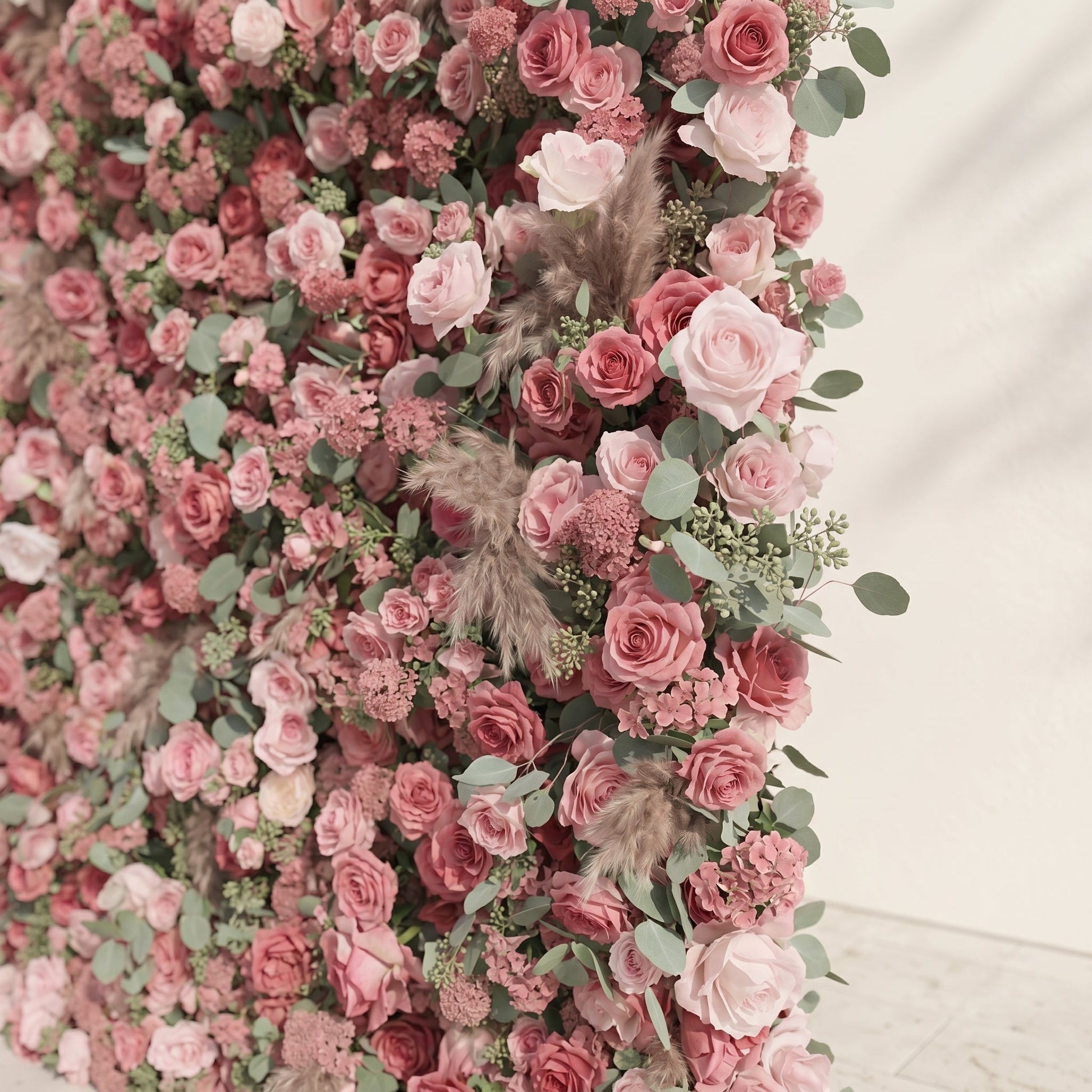 Dusty rose artificial flower wall with eucalyptus detail