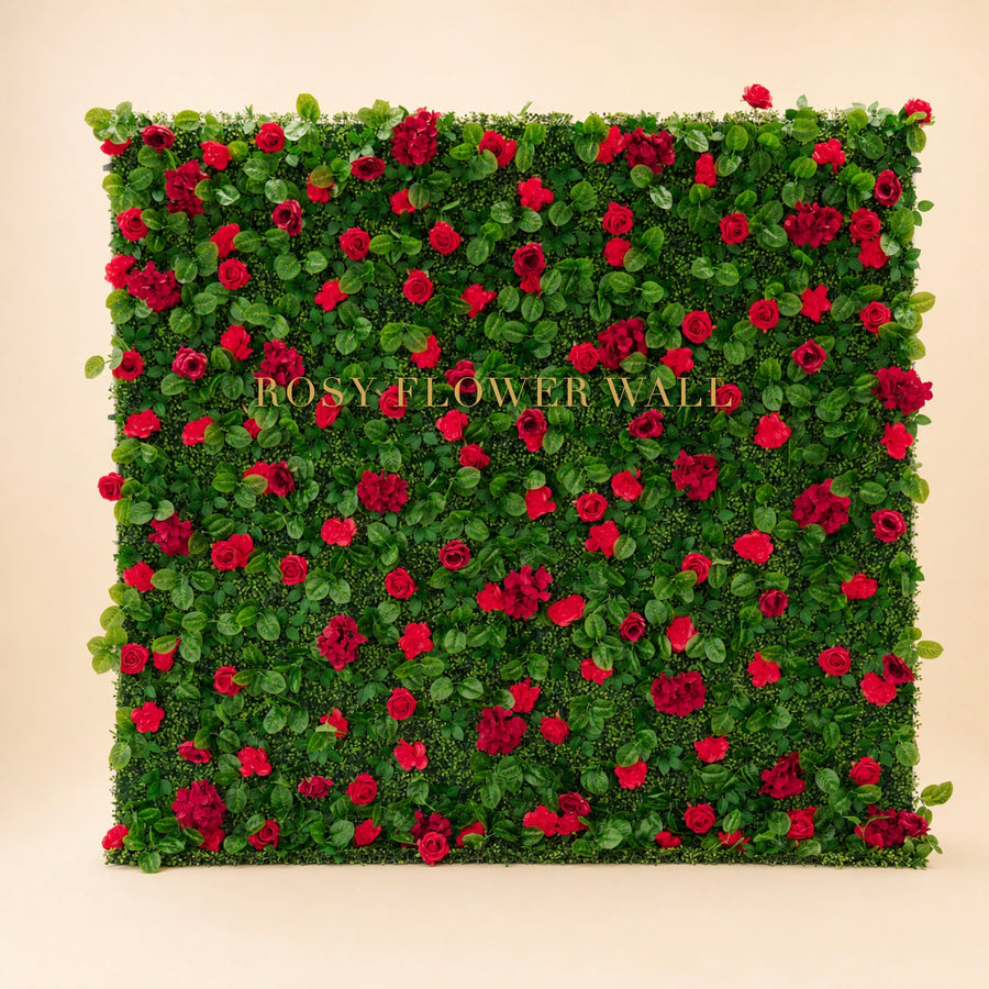 Red rose and greenery flower wall on warm studio background with gold Rosy Flower Wall logo