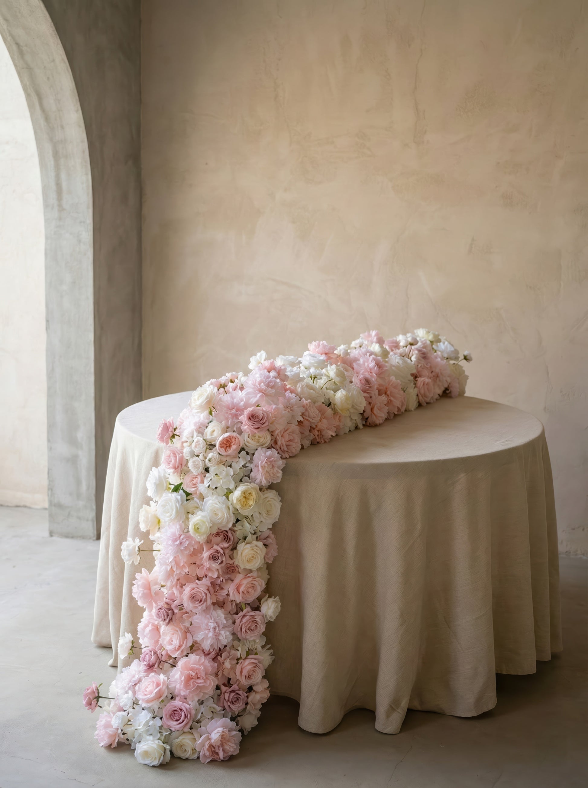 Blush pink and ivory rose artificial flower runner in a warm neutral studio