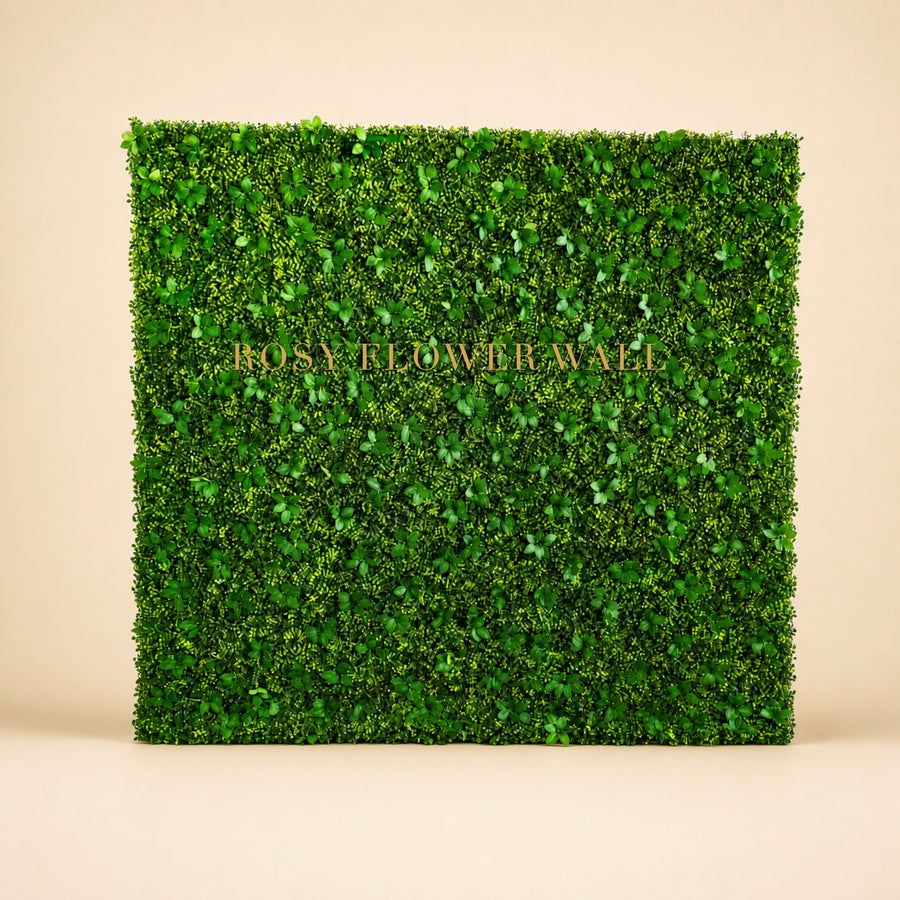 Greenery flower wall backdrop on warm studio background with gold Rosy Flower Wall logo