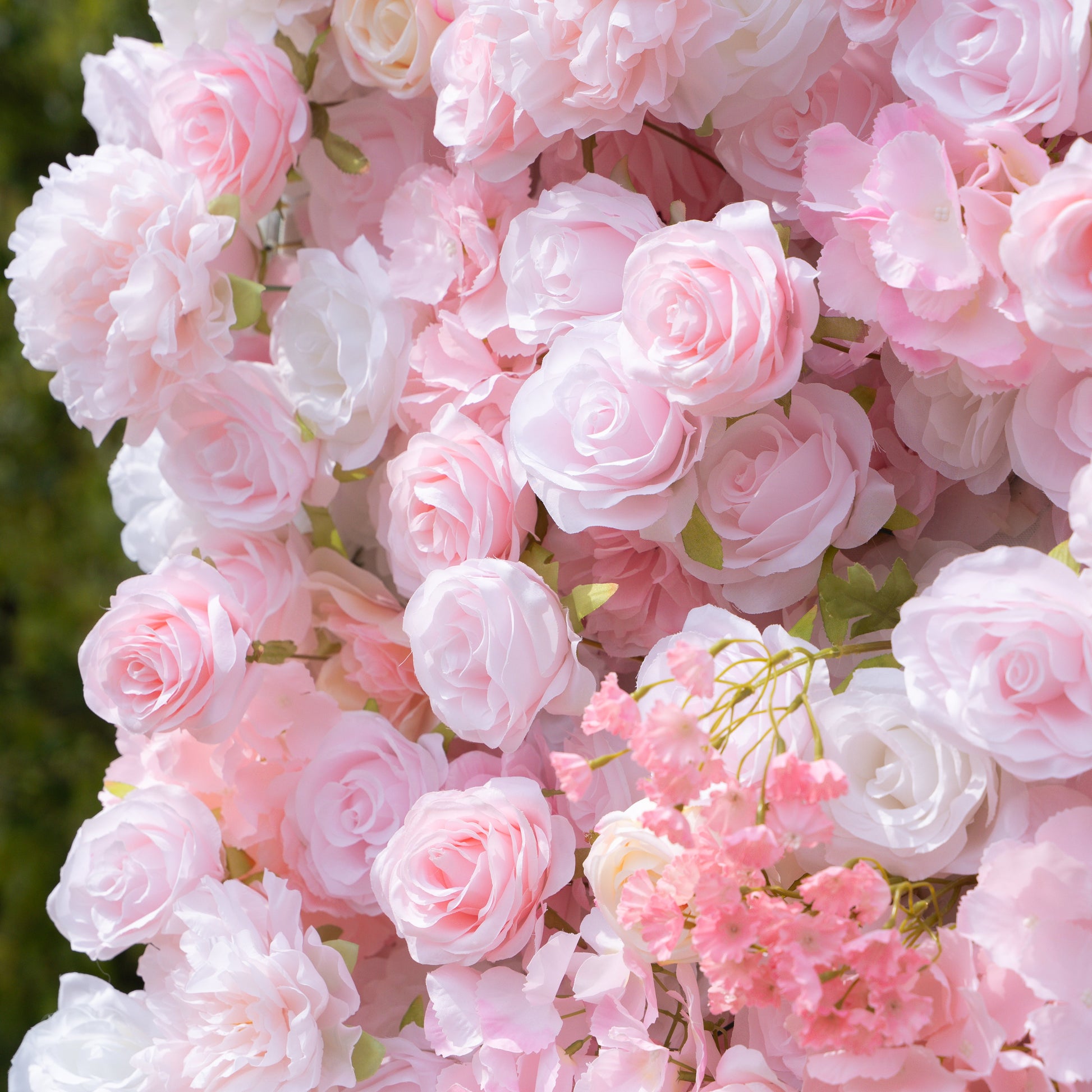 Close-up of pink and white artificial roses and peony-like blooms