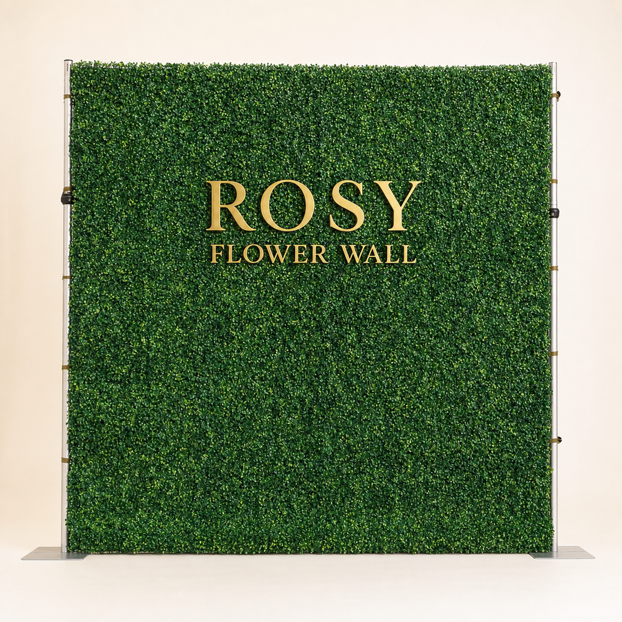 Milan 2D artificial greenery flower wall in warm white studio with gold ROSY FLOWER WALL logo