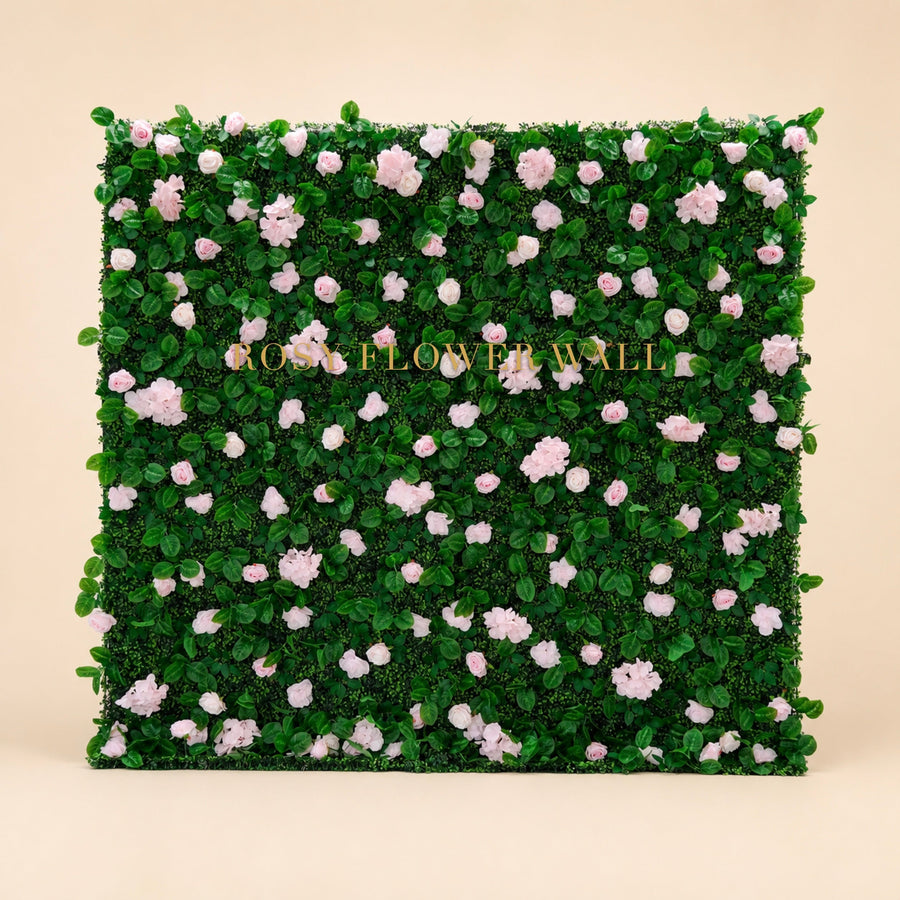 Pink rose and greenery flower wall on warm studio background with gold Rosy Flower Wall logo