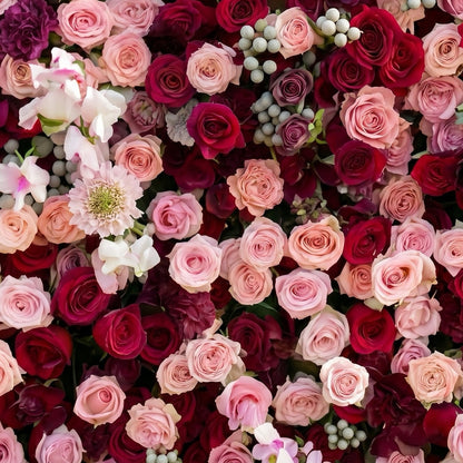 Red and blush pink artificial flower wall close-up detail