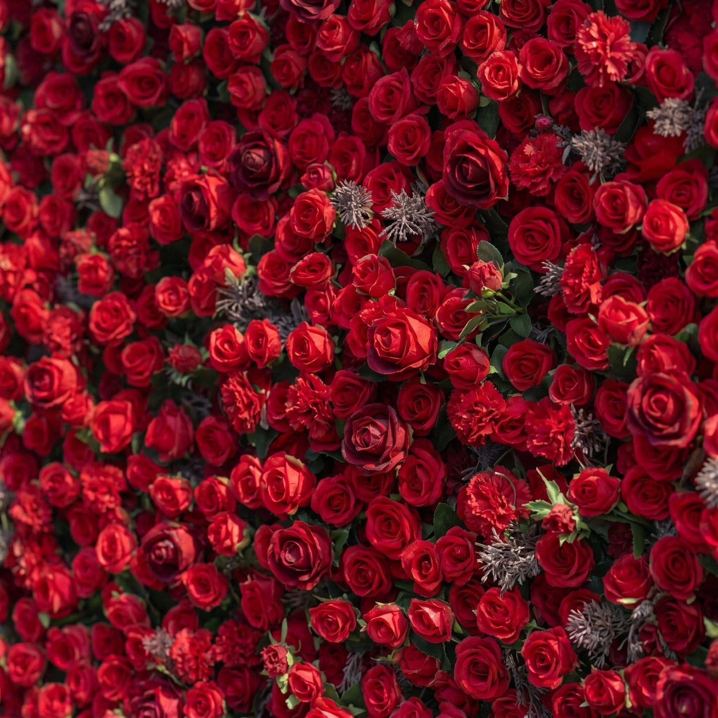 Red artificial rose flower wall close-up detail
