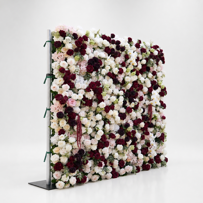 Side view of burgundy ivory and blush flower wall in white studio