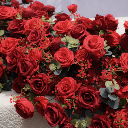 Close-up detail of red roses anemones filler flowers and eucalyptus