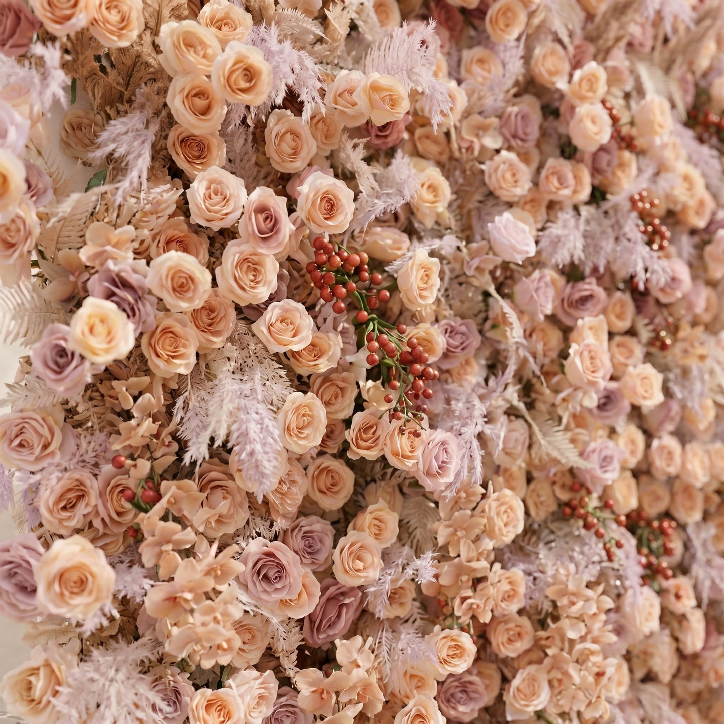 Angled close-up of silk roses and textured foliage on the Rove flower wall