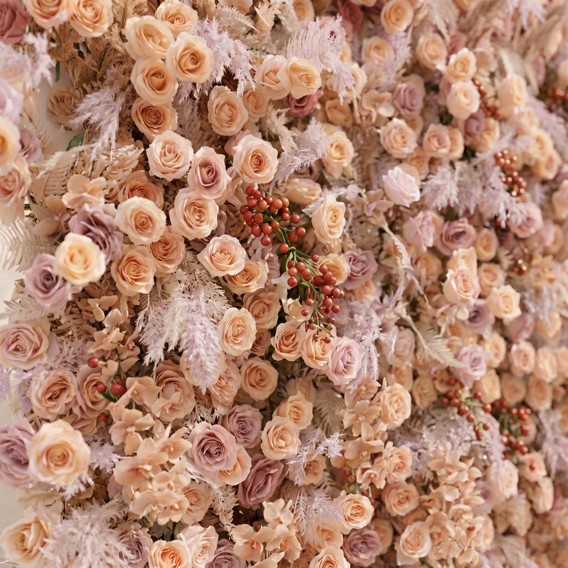 Angled close-up of silk roses and textured foliage on the Rove flower wall