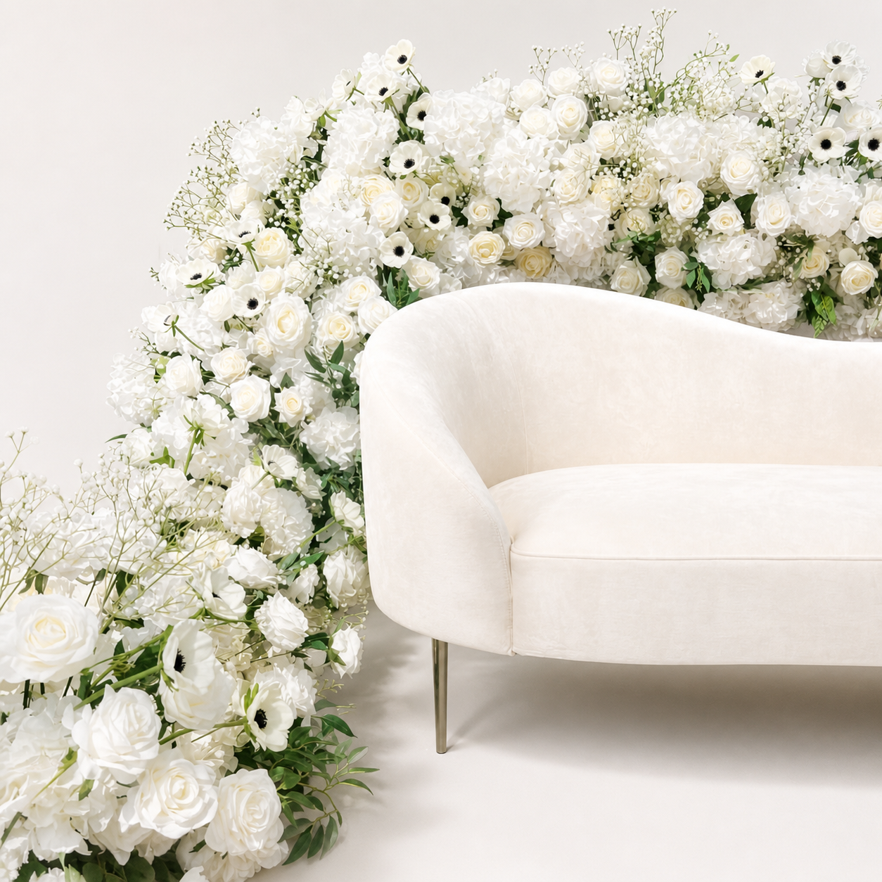 White rose hydrangea and anemone artificial flower runner styled around a cream chair