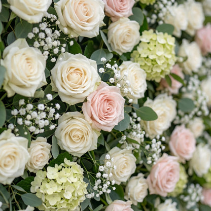 White blush rose and greenery flower wall close-up