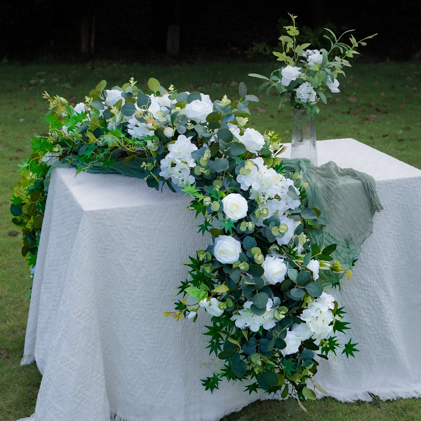 White hydrangea and eucalyptus flower runner styled on a long event table