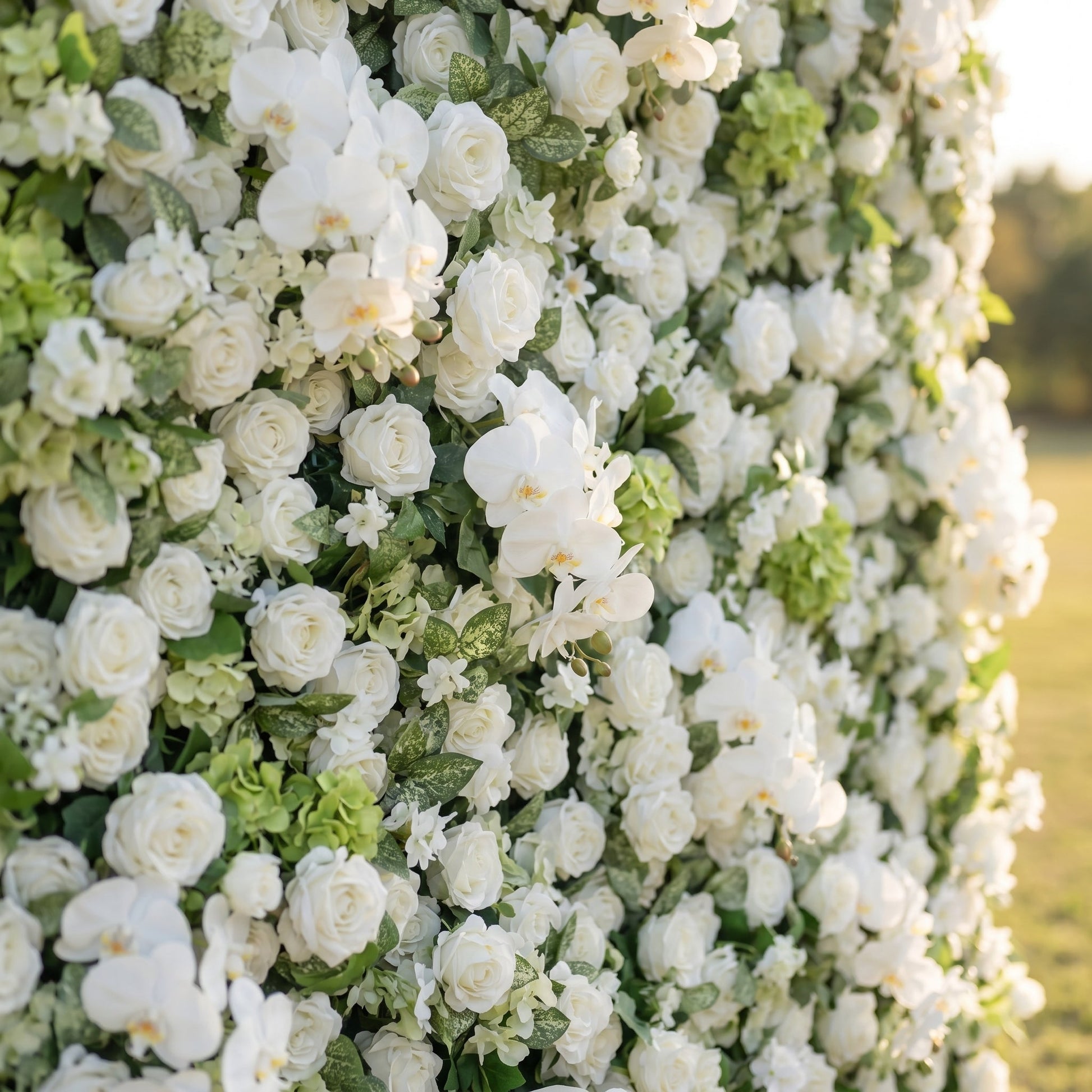 White rose orchid and greenery flower wall close-up