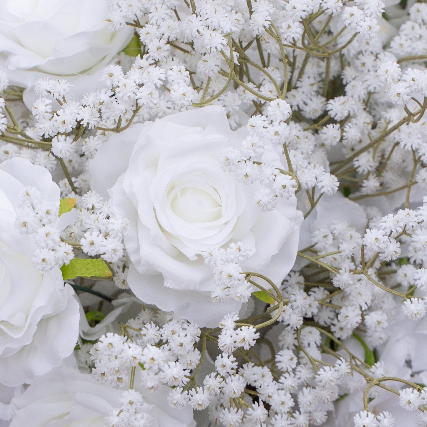 Close-up of white rose and baby's breath artificial flower runner
